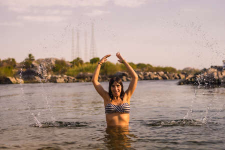 A young tourist bathing in the water of a Nubian village on the river Nile and near the city of Aswan. Egyptの写真素材