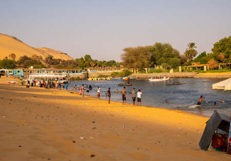 Aswan, Egypt '; October 2020: people from a Nubian village along the Nile River in their traditional wooden boats, near the city of Aswanのeditorial素材