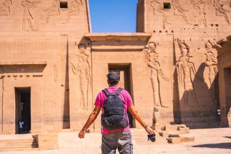 A young photographer at the Temple of Philae, a Greco-Roman construction seen from the Nile River, a temple dedicated to Isis, goddess of love. Aswan. Egyptianの写真素材