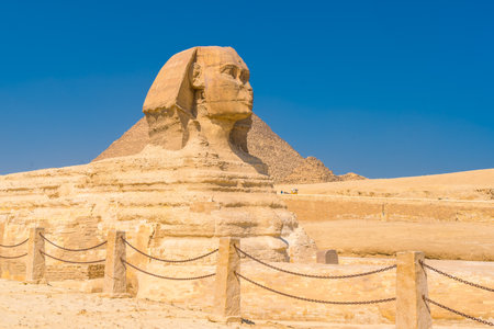 The Great Sphinx of Giza and in the background the Pyramids of Giza one summer afternoon, the oldest Funerary monument in the world. In the city of Cairo, Egyptの写真素材