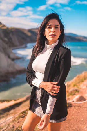 Lifestyle, a young brunette enjoying a summer afternoon on the coast of the Basque country, zumaia. Gipuzkoaの写真素材