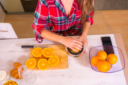 Healthy lifestyle, breakfast with a fresh orange juice in the kitchen of your homeの写真素材