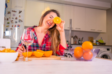 Healthy lifestyle lifestyle, blond Caucasian woman having fun at breakfast with fresh orange juice...