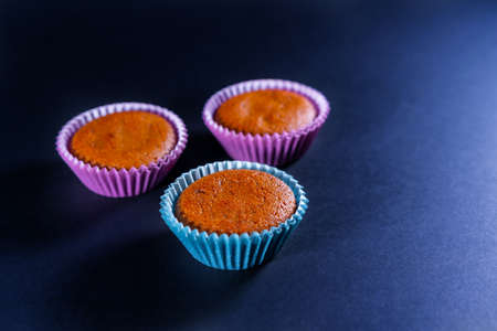 Homemade recipe to cook some carrot muffins at home. Three units piled into the mold before bakingの写真素材