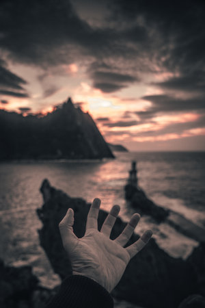 A hand of a young man in the lighthouse of the municipality of Pasajes San Juan in Gipuzkoa. Basque Countryの写真素材