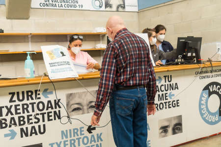 San SebastiÃ¡n, Gipuzkoa. Spain. May 8, 2021: A man identifying himself at the vaccination, vaccination and total immunization center of the covid-19 population. Coronavirusのeditorial素材