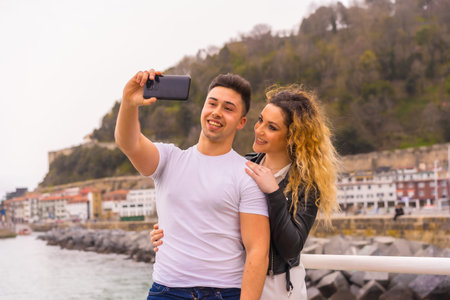 Lifestyle of a Caucasian couple sightseeing on vacation, by the sea taking a photo