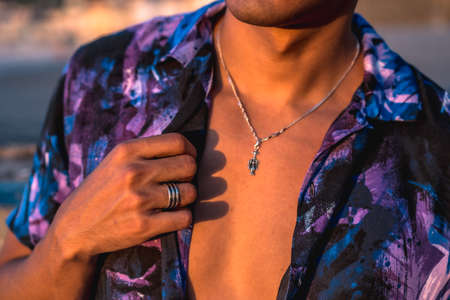Summer lifestyle, a young Latino enjoying summer vacations. with purple flower shirt and sunglasses, hand detailの写真素材