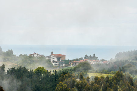 A small town on top of the mountain full of mist. Spring in Ispaster next to Lekeitio, landscapes of...