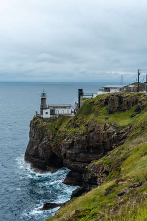 Santa Catalina de Lekeitio lighthouse and its beautiful cliffs on a cloudy spring morning, with the sea in the background, landscapes of Bizkaia. Basque Countryの写真素材