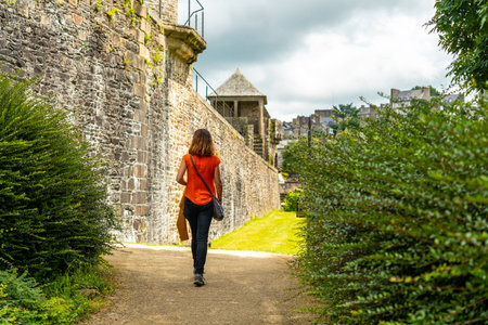 A young tourist visiting the castle of Fougeres. Brittany region, Ille et Vilaine department, Franceのeditorial素材