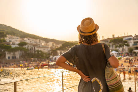 A young tourist at sunset on the coast of Tamariu in the town of Palafrugell. Girona, Costa Brava in the Mediterraneanの写真素材