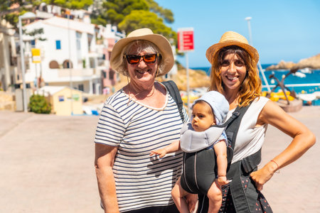 A family on the beach of Sa Tuna on the coast of Begur in summer, Girona on the Costa Brava of...