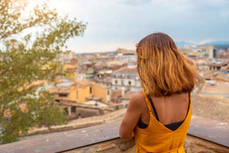 Girona medieval city, a young woman in a viewpoint of the historic center, Costa Brava of Catalonia in the Mediterranean. Spainの写真素材