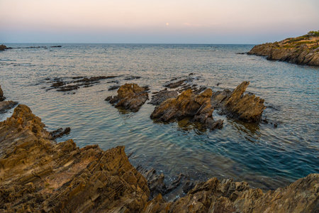 Sunset at Platja De S'arenella in Cadaques, a town on the Costa Brava of Catalonia, Gerona,...