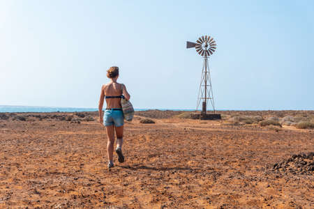 A young woman visiting Las Salinas de Lobos on the Isla de Lobos, off the north coast of the island of Fuerteventura, Canary Islands. Spainの写真素材