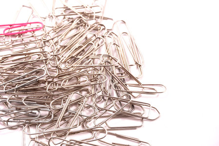 Detail of paper clips on a white background, copy and paste space