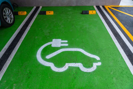 Electric car green color parking for parking and charging. Vehicles to improve the environment without gasolineの写真素材