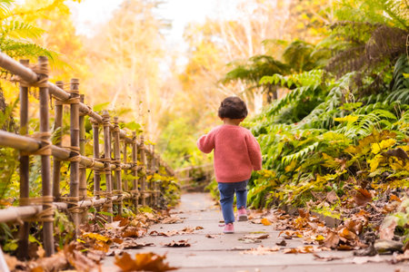 A girl running through a beautiful park in autumnの写真素材