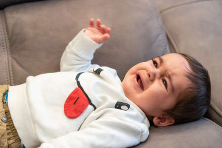 Baby crying with the pain of his first teethの写真素材