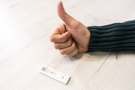 He was lucky and the test was negative. A young woman doing the rapid antigen test at her home, sars-cov-2, coronavirus, covid-19の写真素材