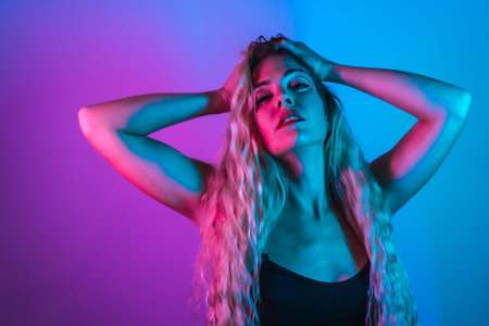 Portrait of a Caucasian blonde girl with eye drawing makeup, groomed eyelashes on a blue background...