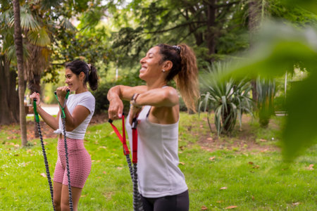Latin girl doing sports in a green park, lifestyle a healthy life, female students exercising with...