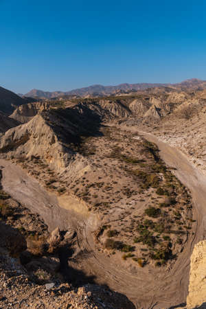 Precious curve in the path of the desert canyon of Tabernas, province of AlmerÃ­a, Andalusia. On a trek in the Rambla del Infiernoの写真素材