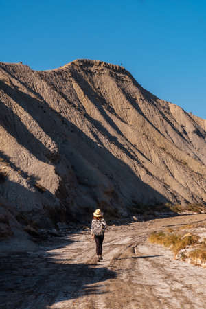 A young hiker with backpack and hat in the desert of Tabernas, AlmerÃ­a province, Andalusia. On a trek in the Rambla del Infiernoの写真素材