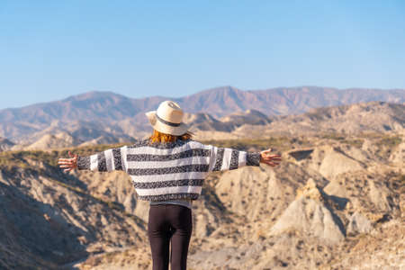 A young hiker enjoying freedom in the desert canyon of Tabernas, AlmerÃ­a province, Andalusia. On a trek in the Rambla del Infiernoの写真素材