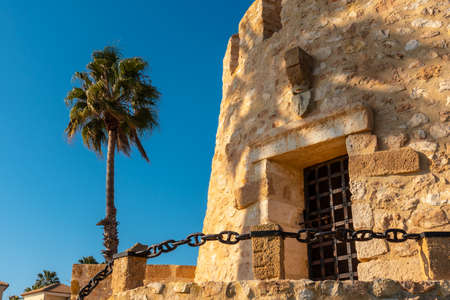 Detail of the Torre del Moro in the park in the coastal town of Torrevieja, Alicante, Valencian Community. Spain, Mediterranean Sea on the Costa Blanca, vertical photoの写真素材