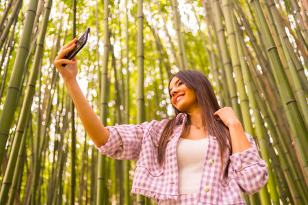 Young caucasian girl with a pink skirt in a bamboo forest. Enjoying summer holidays in a tropical...