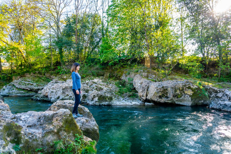 A young tourist enjoying the Sella river near the town of Cangas de Onis. Asturias. Spain