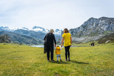Three generations visiting Lake Ercina in the Lakes of Covadonga. Asturias. Spainの写真素材