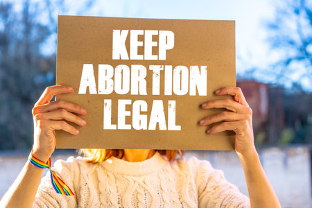 A woman holding a sign in favor of the legalization of abortion. Protest not to make abortion illegal in the united states, pro-choice, pro-lifeの写真素材