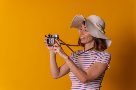 Portrait of a caucasian girl in tourist concept smiling with a hat and sunglasses taking a photo and...