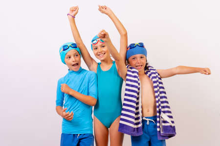 Portrait of brothers dressed in swimsuits for swimming lessons in the pool. white backgroundの写真素材