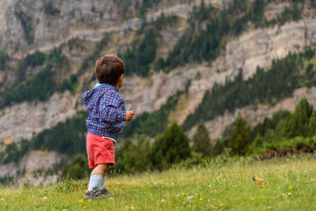 A one year old baby in nature in the Tena valley in the Pyrenees, Huesca, Spainの写真素材