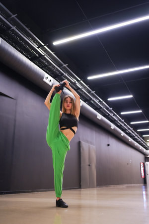 Woman urban hip-hop dancer inside a black building buildingの写真素材