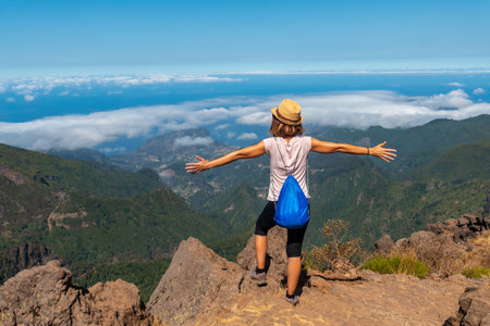 A young woman strolling at the Miradouro do Juncal on Pico do Arieiro, Madeira. Portugalの写真素材