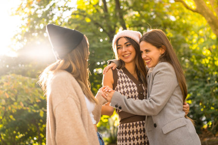 Autumn lifestyle, women friends having fun in a park in autumn at sunsetの写真素材