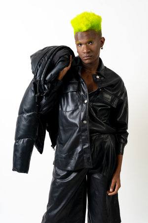 Black ethnic man in studio with white background, LGTBI concept, leather jacketの写真素材