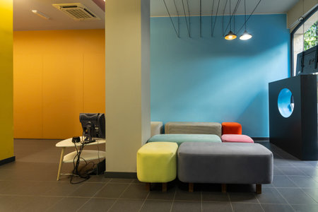 Waiting room of a modern dental clinic, without people with colored sofas in a cityの写真素材