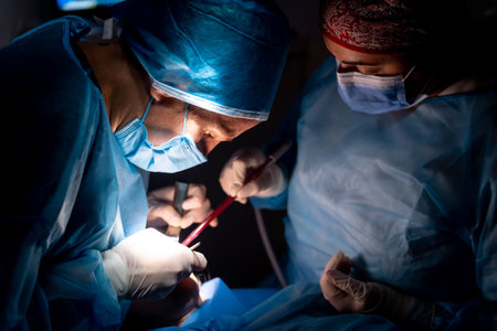 Dental clinic, dentist doctor and the assistant performing an oral operation in the dark to a clientの写真素材