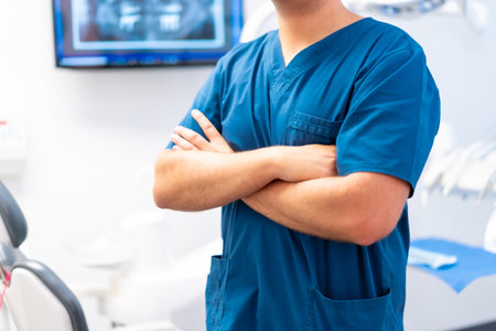 Dental clinic, unrecognizable caucasian male dentist with arms crossedの写真素材