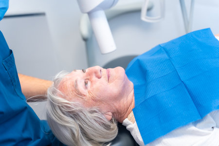 Dental clinic, elderly woman lying at the dentist on denture checkupの写真素材