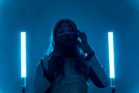 Futuristic, silhouette of a young woman, with augmented reality glasses looking at the cameraの写真素材