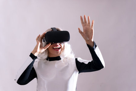 Close-up of adult woman gesturing with virtual reality goggles, metaverse