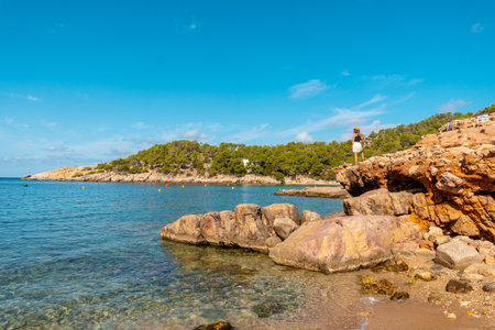 Vacation concept, A young woman at Salada y Saladeta beach enjoying the coast. Balearicの写真素材
