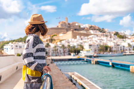 Young woman visiting coastal Ibiza town on vacation from Al Faro, Balearic Islandsの写真素材